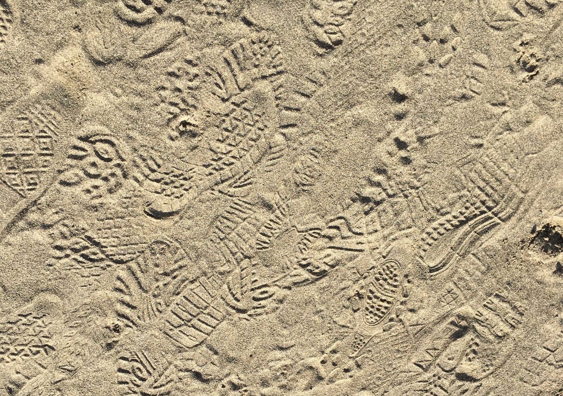 image of shoe prints in the sand