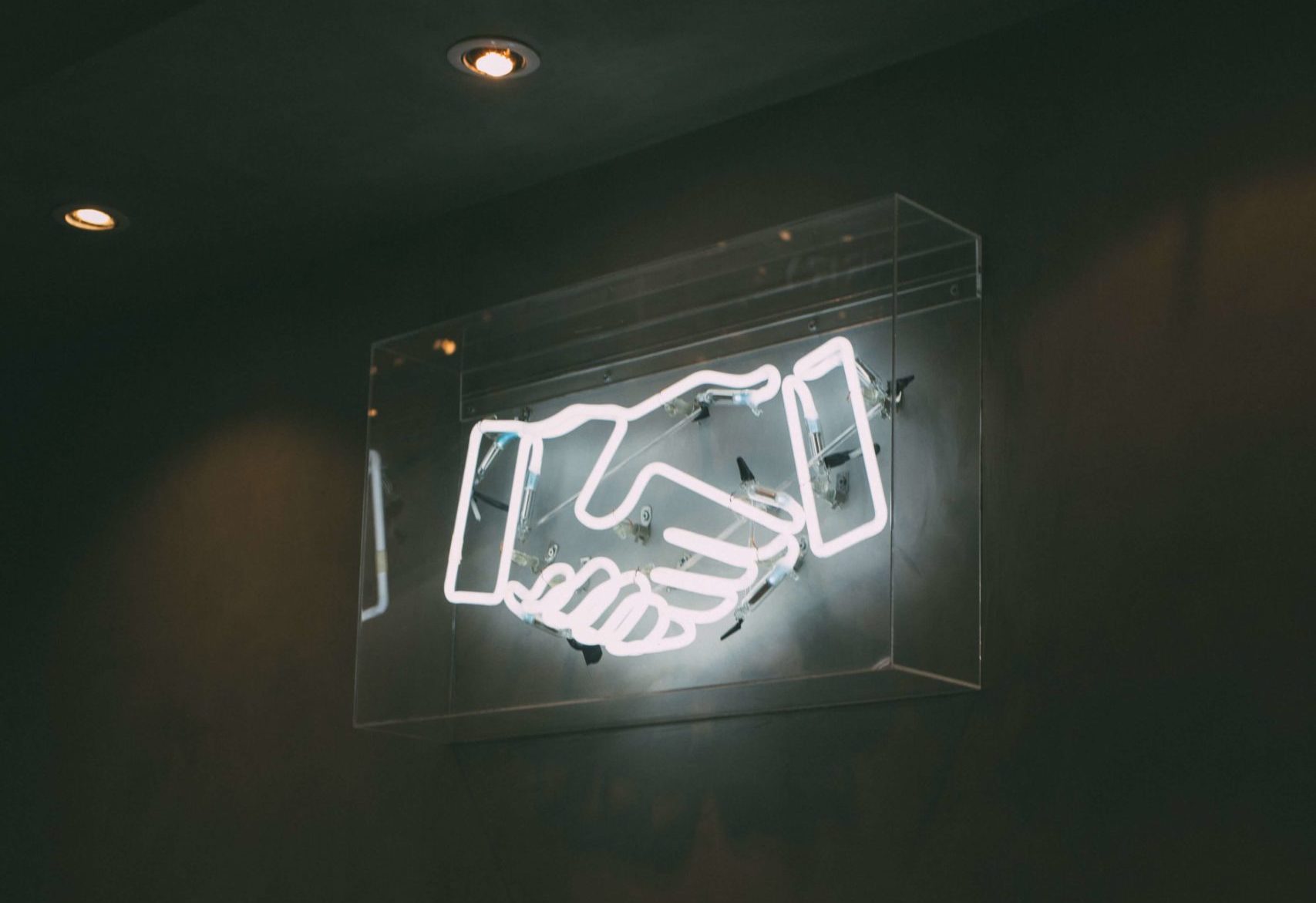 image of neon handshake emoji